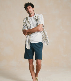 Man wearing Dockers® Alpha Chino Shorts in casual outdoor setting, showcasing versatile summer style.