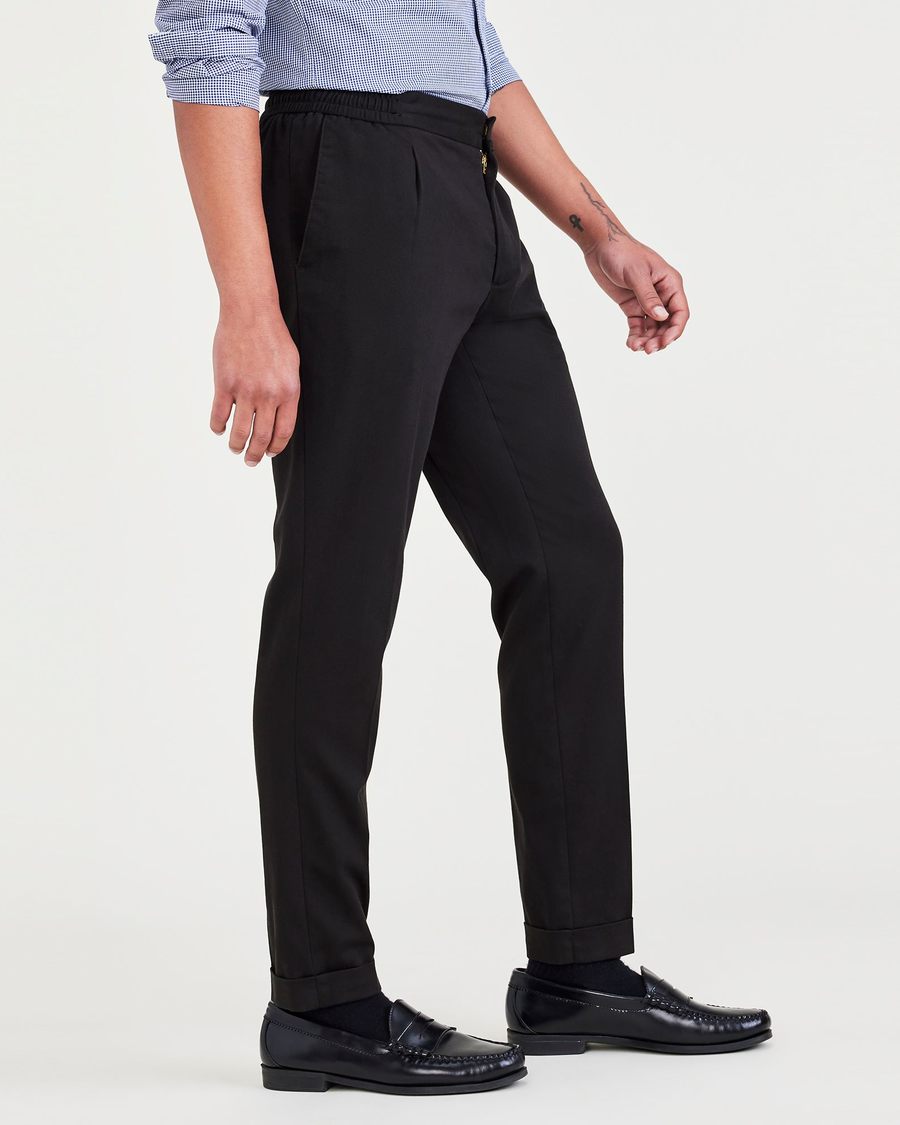 Side view of model wearing Beautiful Black Men's Slim Tapered Fit Refined Pull-On Pants.