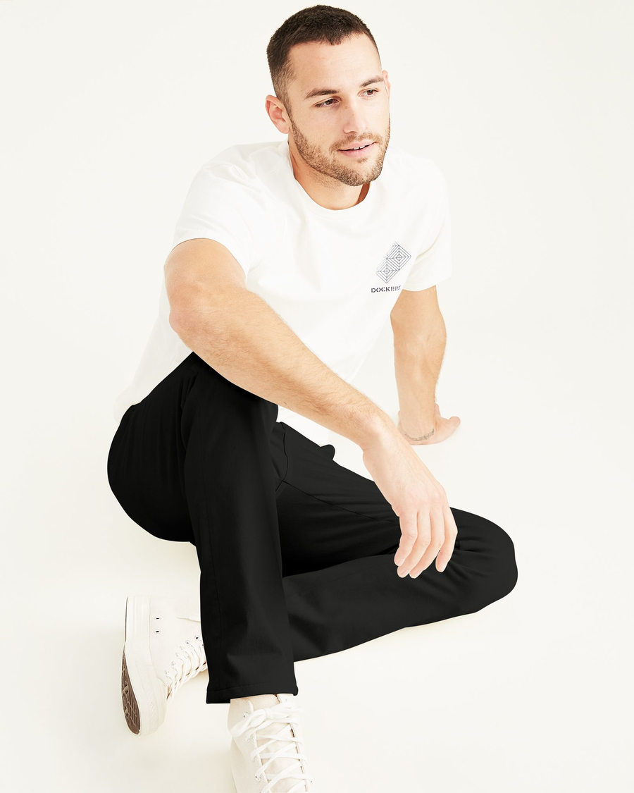 View of model wearing Black Men's Skinny Fit Supreme Flex Alpha Khaki Pants.