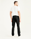 Back view of model wearing Black Men's Skinny Fit Supreme Flex Alpha Khaki Pants.