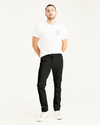 Front view of model wearing Black Men's Skinny Fit Supreme Flex Alpha Khaki Pants.