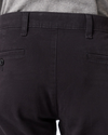 View of model wearing Black Men's Slim Fit Smart 360 Flex Ultimate Chino Pants.