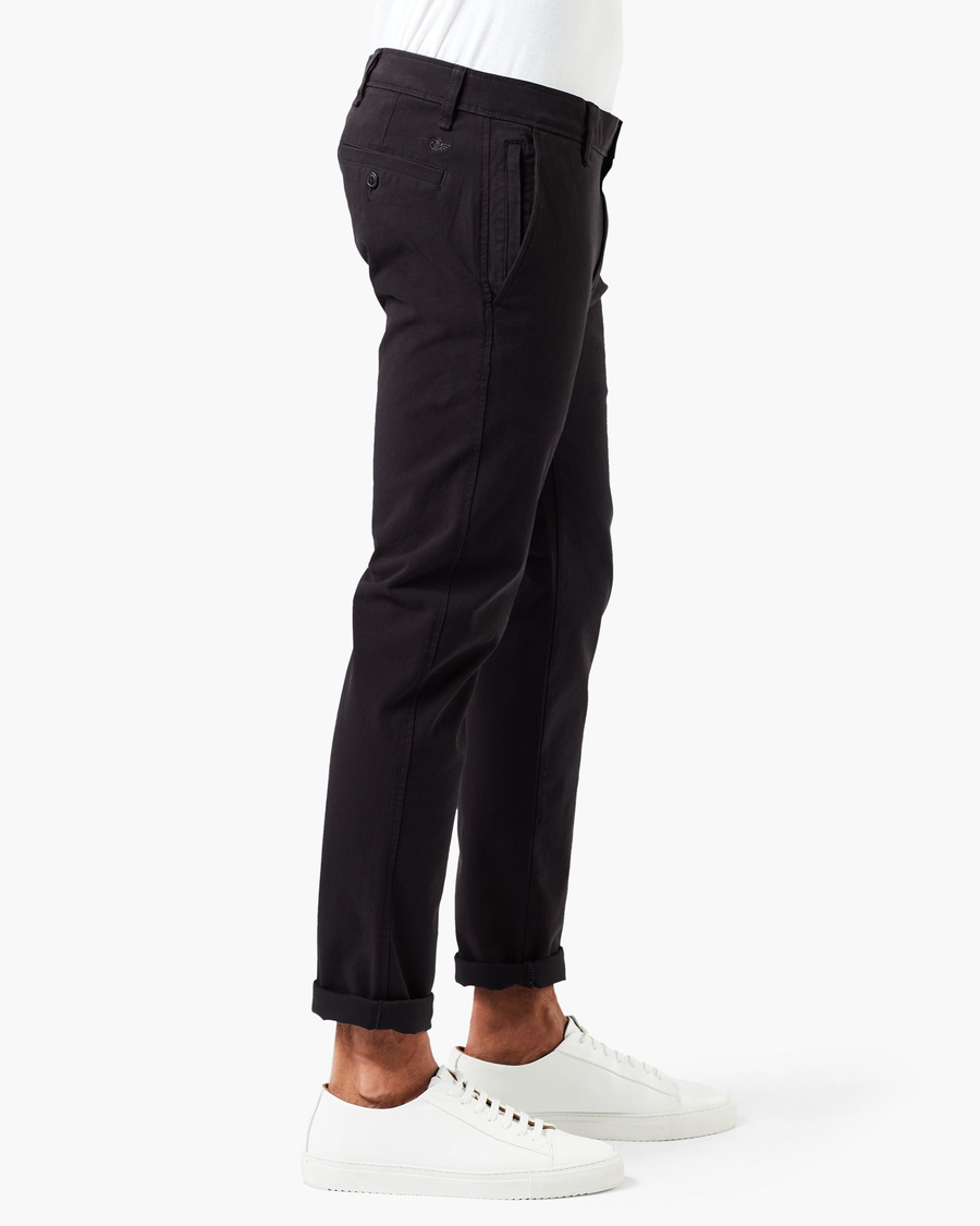 Side view of model wearing Black Ultimate Chinos, Skinny Fit.