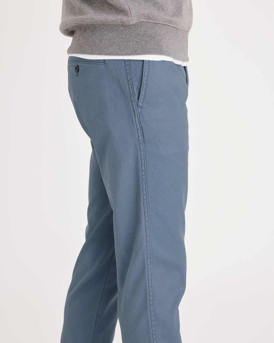 Side view of model wearing Bluefin Men's Slim Fit Original Chino Pants.