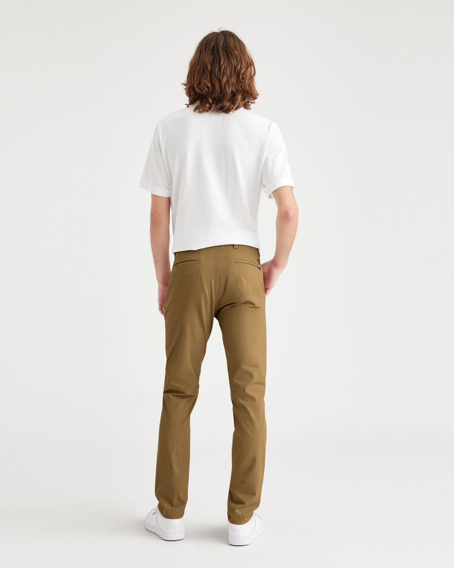 Back view of model wearing Bronze Brown Men's Skinny Fit Smart 360 Flex California Chino Pants.