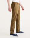 Side view of model wearing Bronze Brown Men's Slim Fit Smart 360 Flex California Chino Pants.