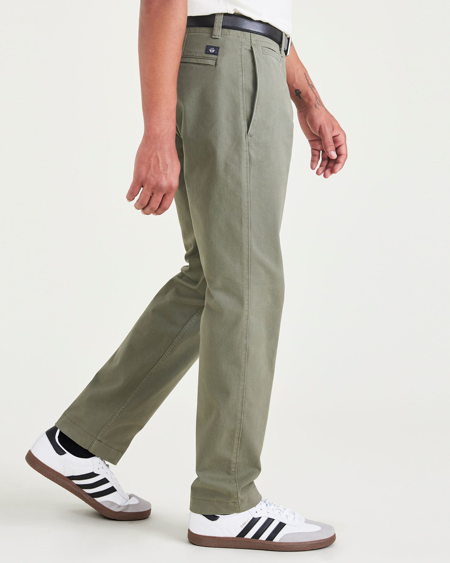 Side view of model wearing Camo Men's Slim Fit Smart 360 Flex California Chino Pants.