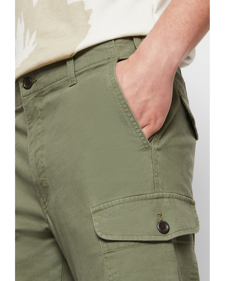 View of model wearing Camo Men's Slim Tapered Fit Cargo Pants.