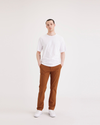 Front view of model wearing Caramel Café Men's Slim Fit Smart 360 Flex Alpha Chino Pants.