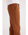 Side view of model wearing Caramel Café Men's Slim Fit Smart 360 Flex Alpha Chino Pants.