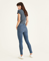 Back view of model wearing Cassidy Light Rinse Women's Mid-Rise Skinny Jean Cut Pants.