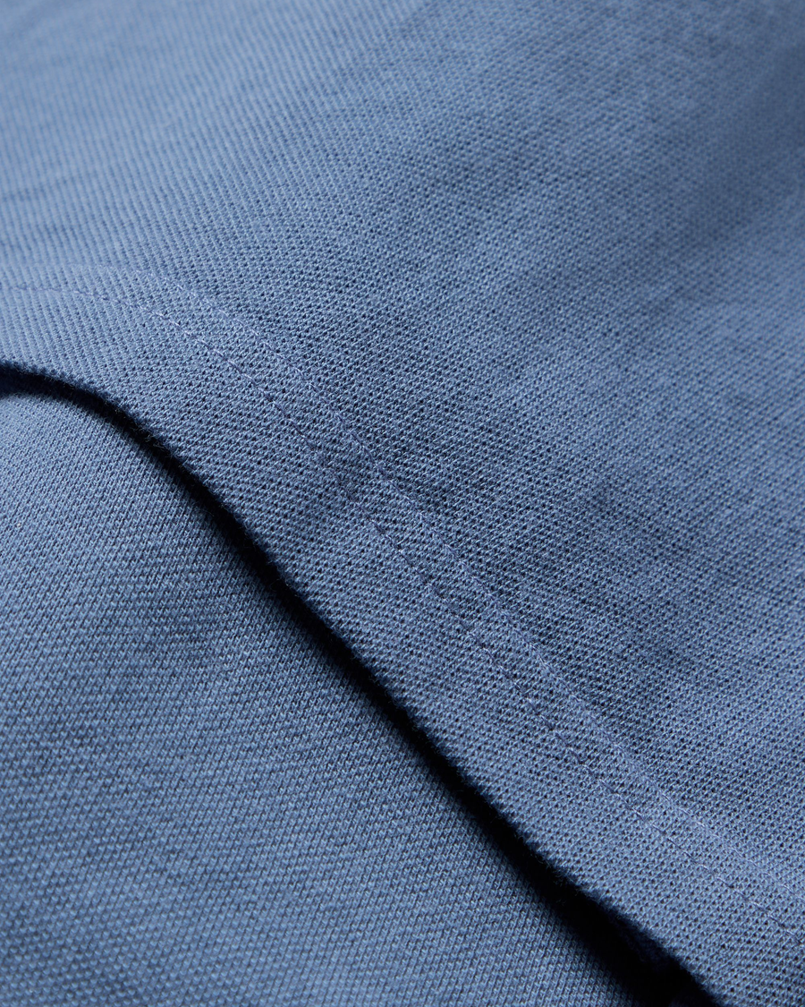 View of model wearing Coastal Fjord Pique Polo, Slim Fit.