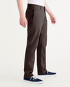 Side view of model wearing Coffee Bean Men's Slim Fit Smart 360 Flex California Chino Pants.