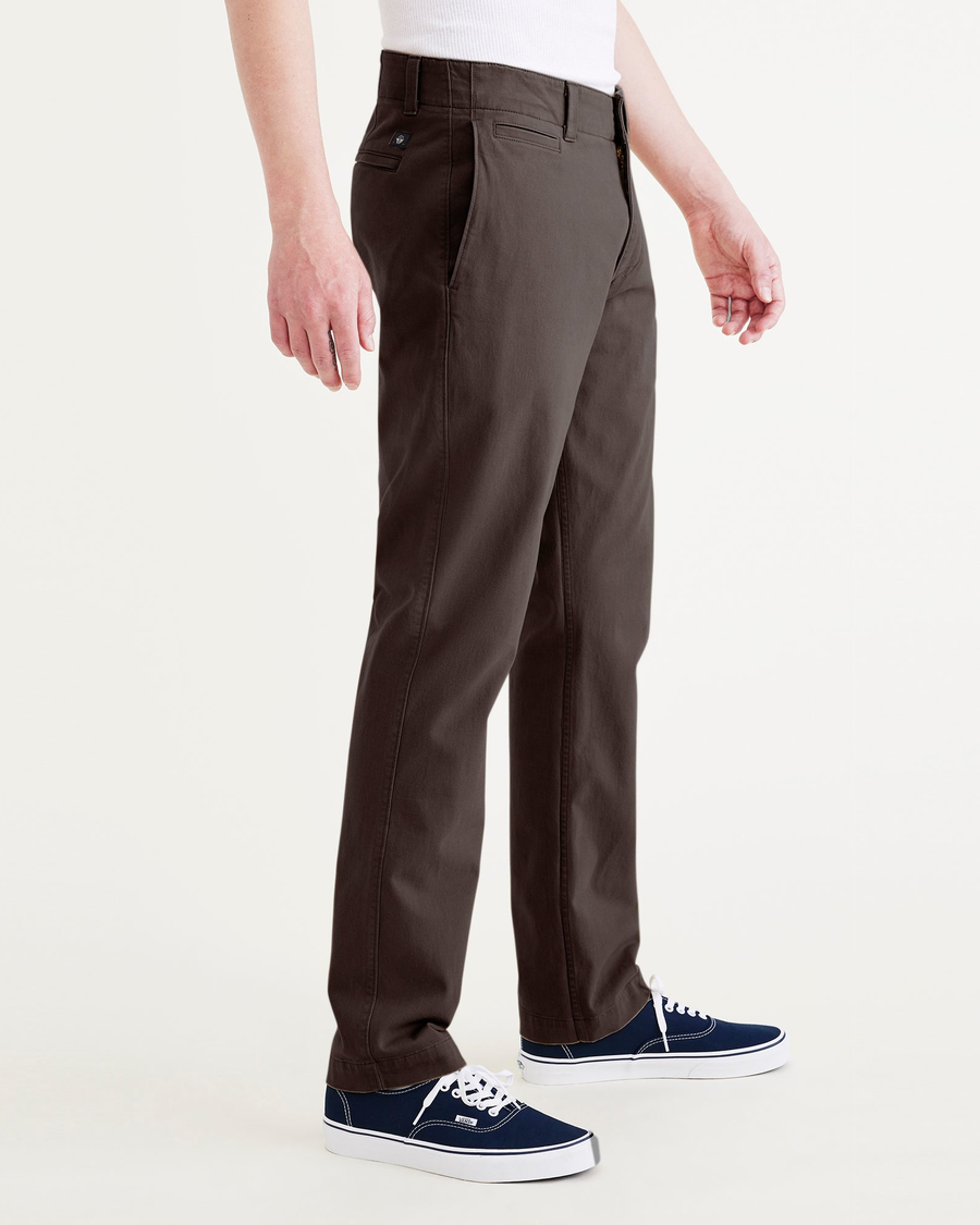 Side view of model wearing Coffee Bean Men's Slim Fit Smart 360 Flex California Chino Pants.