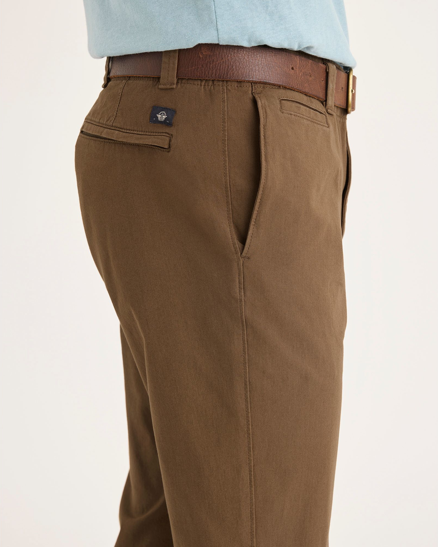 Side view of model wearing Coffee Liquer Alpha Chino Pants, Slim Fit.