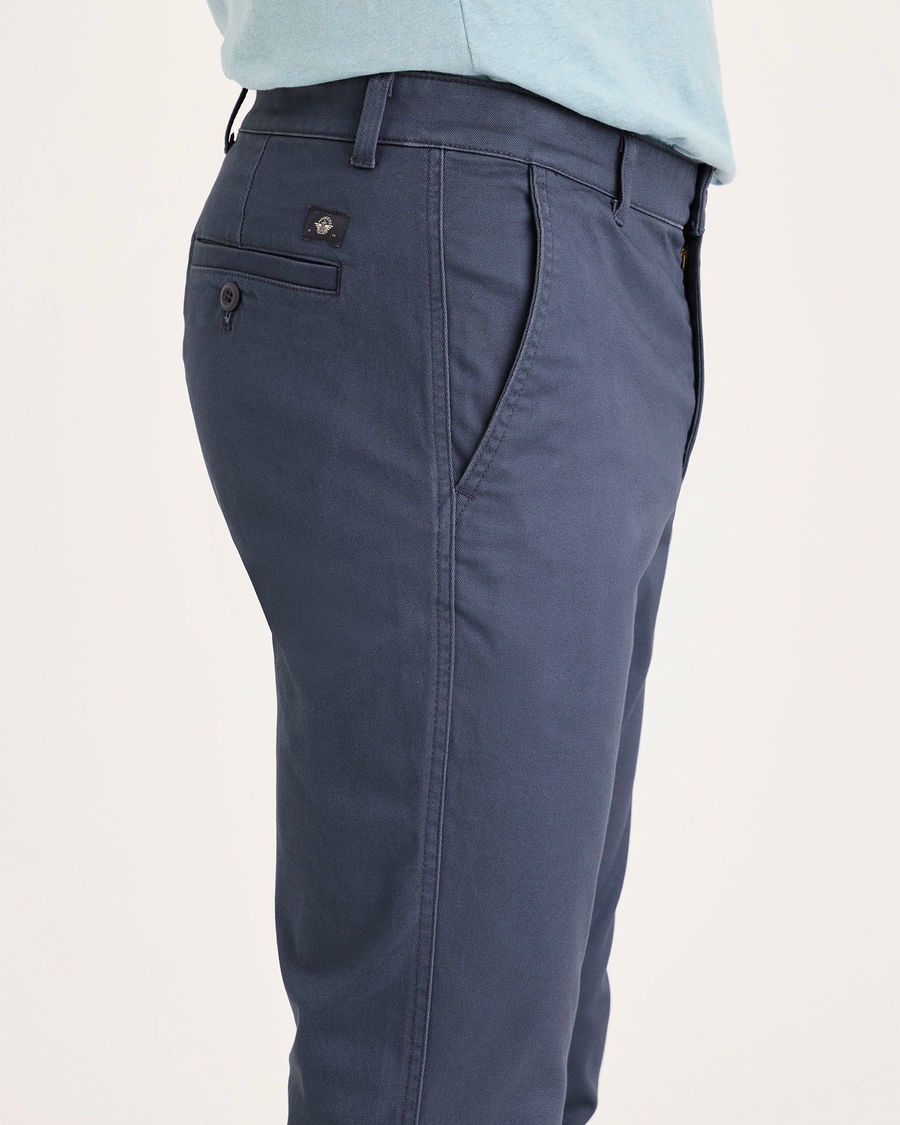 Side view of model wearing Crown Blue Men's Skinny Fit Original Chino Pants.