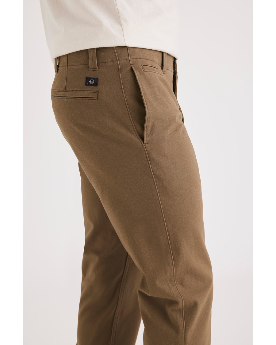 Side view of model wearing Cub Alpha Chino Pants, Slim Fit.