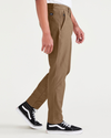 Side view of model wearing Cub Men's Skinny Fit Smart 360 Knit Chino Pants.