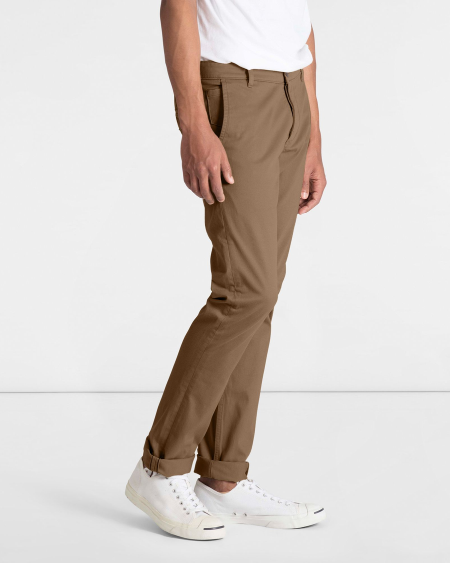 Side view of model wearing Cub Men's Skinny Fit Supreme Flex Alpha Khaki Pants.