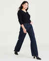 View of model wearing Dark Indigo Stonewash Women's Relaxed Fit Mid-Rise Jeans.