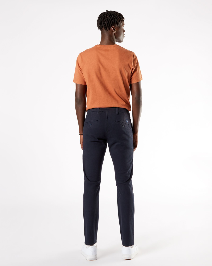 Back view of model wearing Dockers Navy Men's Skinny Fit Supreme Flex Alpha Khaki Pants.