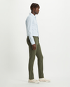 Side view of model wearing Dockers Olive Men's Skinny Fit Smart 360 Flex Alpha Khaki Pants.