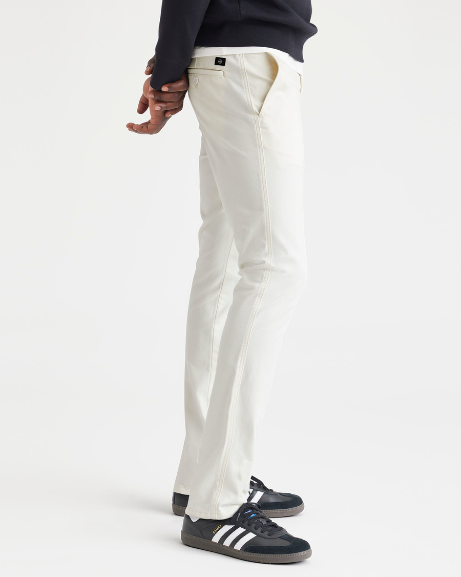 Side view of model wearing Egret Men's Skinny Fit Original Chino Pants.