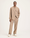 Front view of model wearing Fossil Men's Loose Fit Eighty-Six Original Pleated Chino Pants.