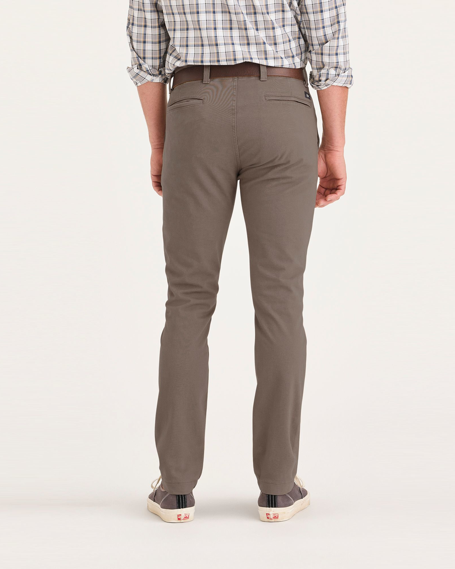 Back view of model wearing Fossil Men's Skinny Fit Smart 360 Flex California Chino Pants.