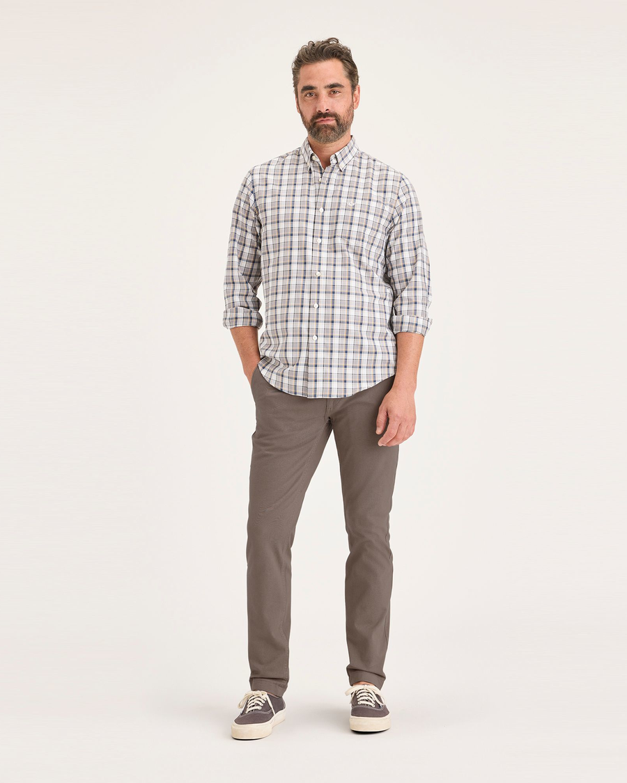 Front view of model wearing Fossil Men's Skinny Fit Smart 360 Flex California Chino Pants.