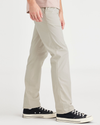 Side view of model wearing Grit Men's Slim Fit Original Chino Pants.