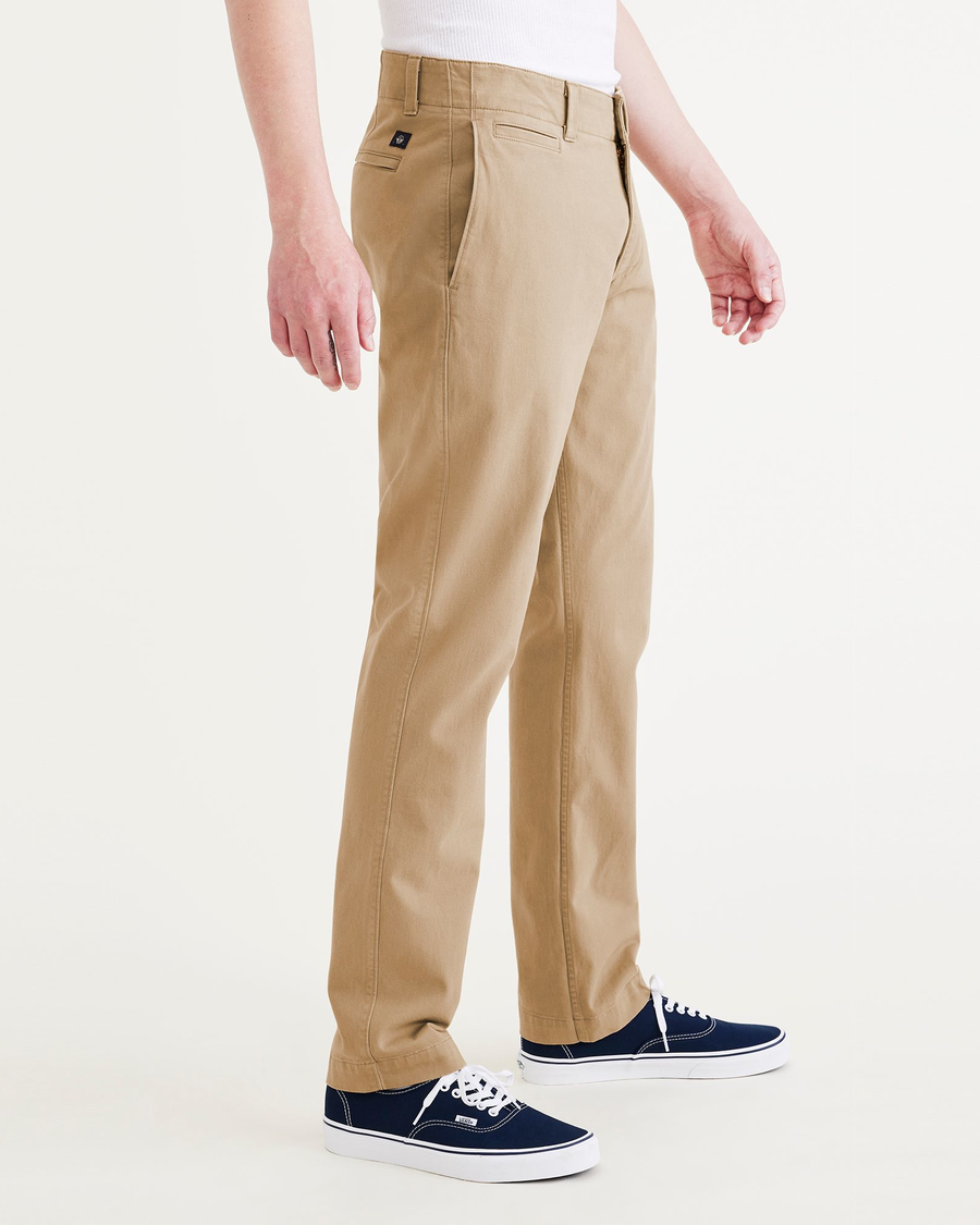 Side view of model wearing Harvest Gold Alpha Chino Pants, Slim Fit.