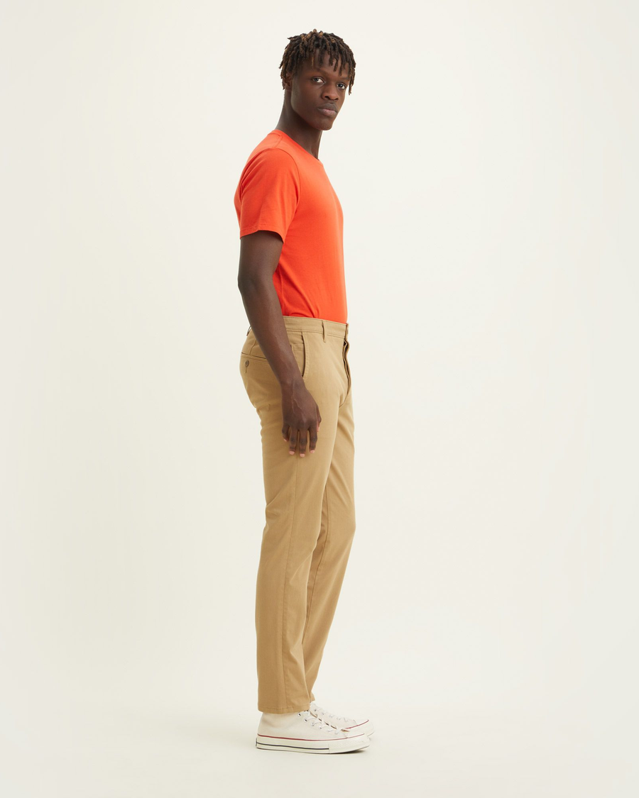 Side view of model wearing Harvest Gold Big and Tall Tapered Fit Supreme Flex Pants.