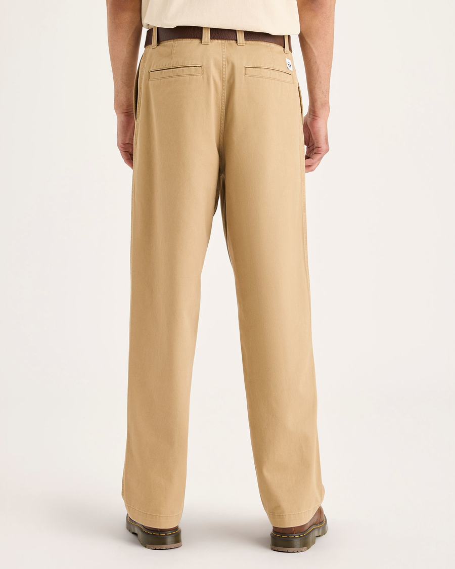 Back view of model wearing Harvest Gold Eighty-Six Alpha Chino Pants, Loose Fit.