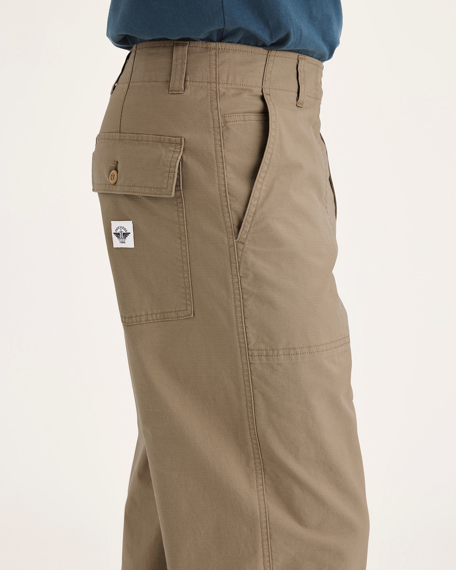 Side view of model wearing Harvest Gold Men's Loose Fit Eighty-Six Utility Pants.