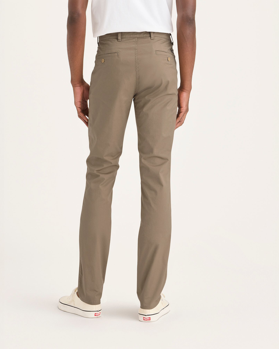 Back view of model wearing Harvest Gold Men's Skinny Fit Original Chino Pants.