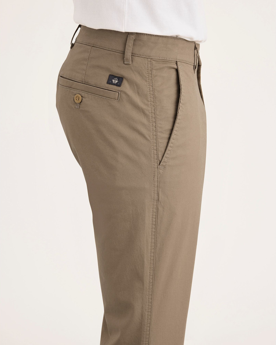 Side view of model wearing Harvest Gold Men's Skinny Fit Original Chino Pants.