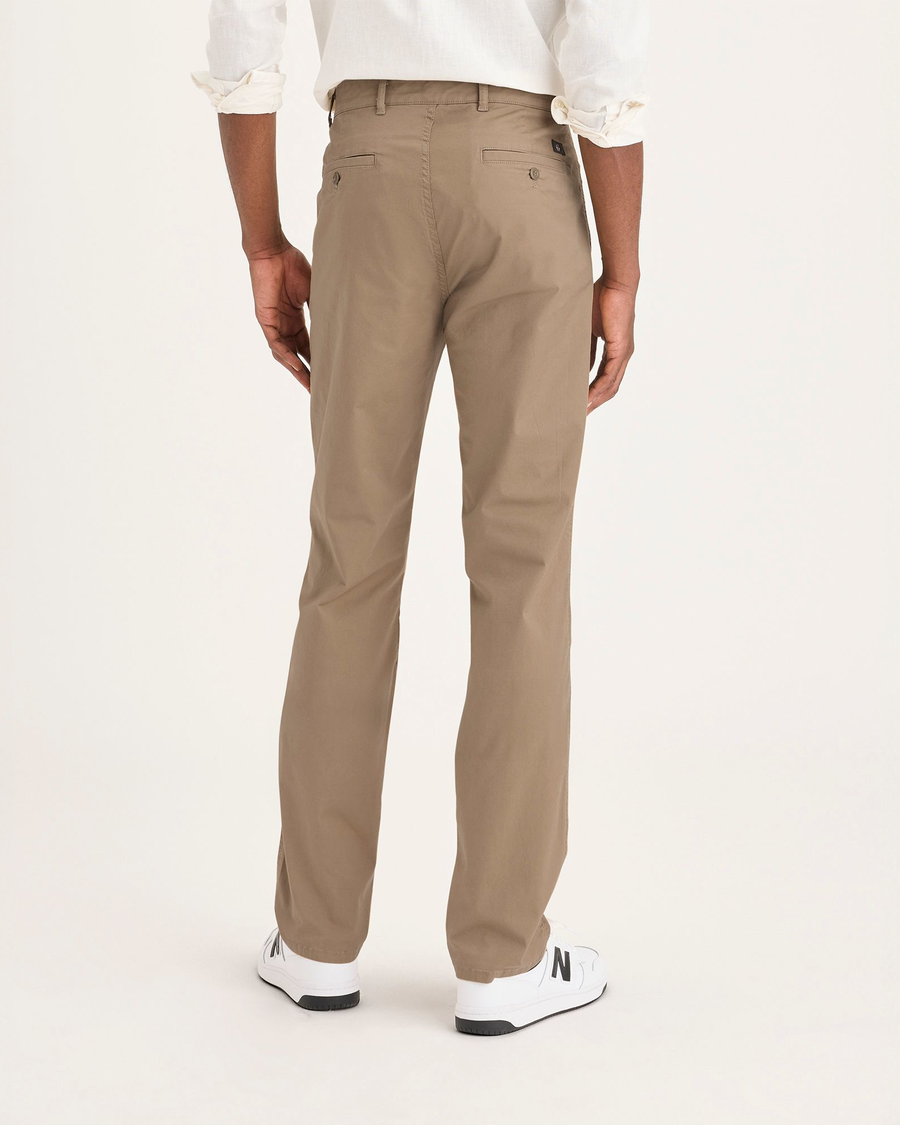 Back view of model wearing Harvest Gold Men's Slim Fit Original Chino Pants.