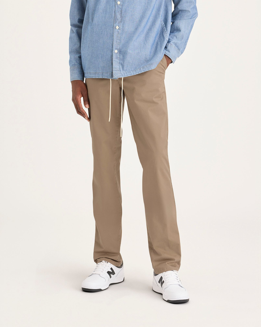 Front view of model wearing Harvest Gold Men's Slim Fit Original Chino Pants.