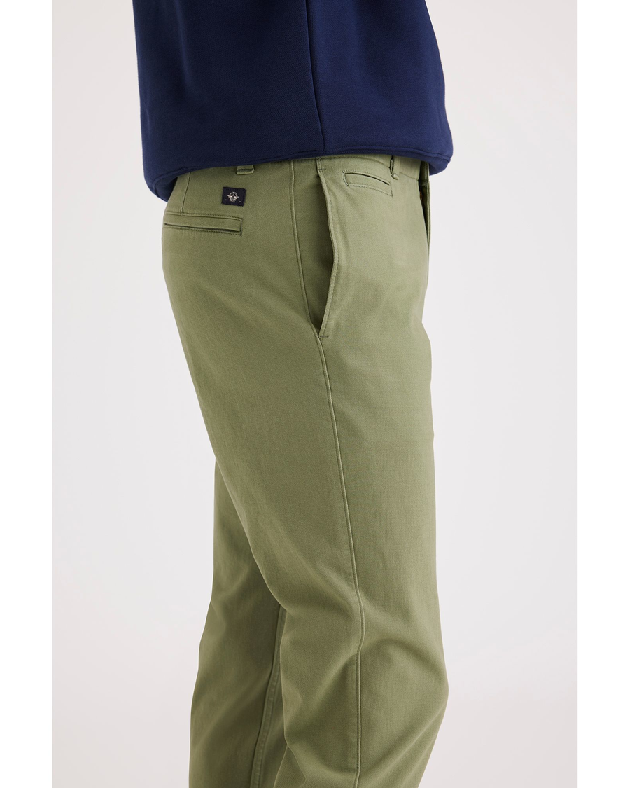 Side view of model wearing Loden Green Men's Slim Fit Smart 360 Flex California Chino Pants.