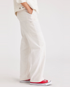 Side view of model wearing Lucent White Women's Straight Fit Carpenter Pants.