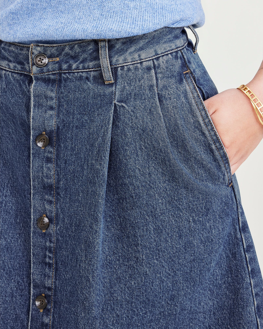 View of model wearing Medium Indigo Stonewash Women's Midi Skirt.