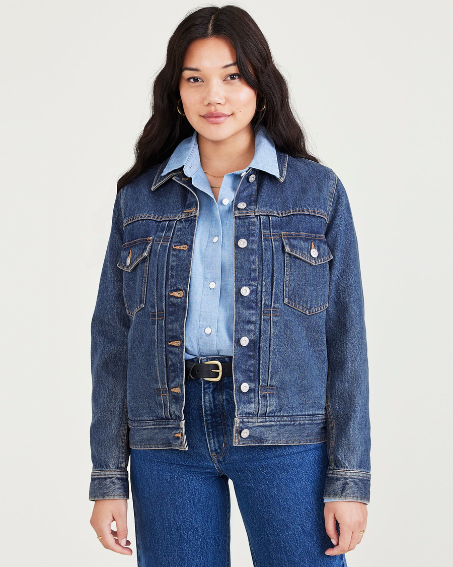 Front view of model wearing Medium Indigo Stonewash Women's Regular Fit Original Trucker Jacket.