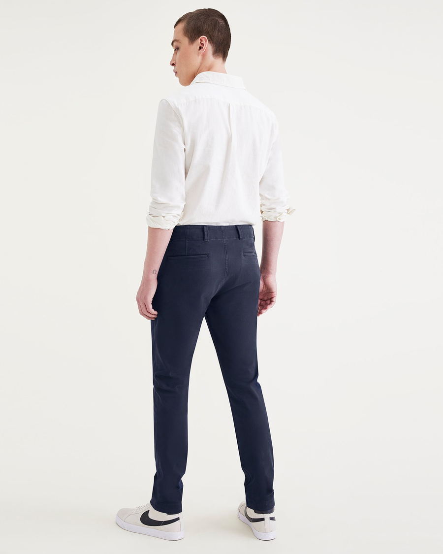 Back view of model wearing Navy Blazer Alpha Chino Pants, Skinny Fit.