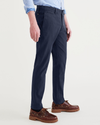 Side view of model wearing Navy Blazer Men's Slim Fit Smart 360 Flex California Chino Pants.