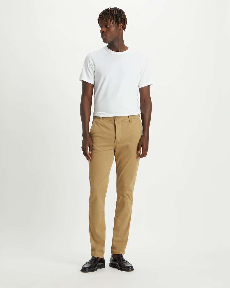 Front view of model wearing New British Khaki Men's Skinny Fit Supreme Flex Alpha Khaki Pants.