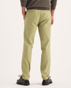 Back view of model wearing New British Khaki Signature Iron Free Khakis, Skinny Fit with Stain Defender®.
