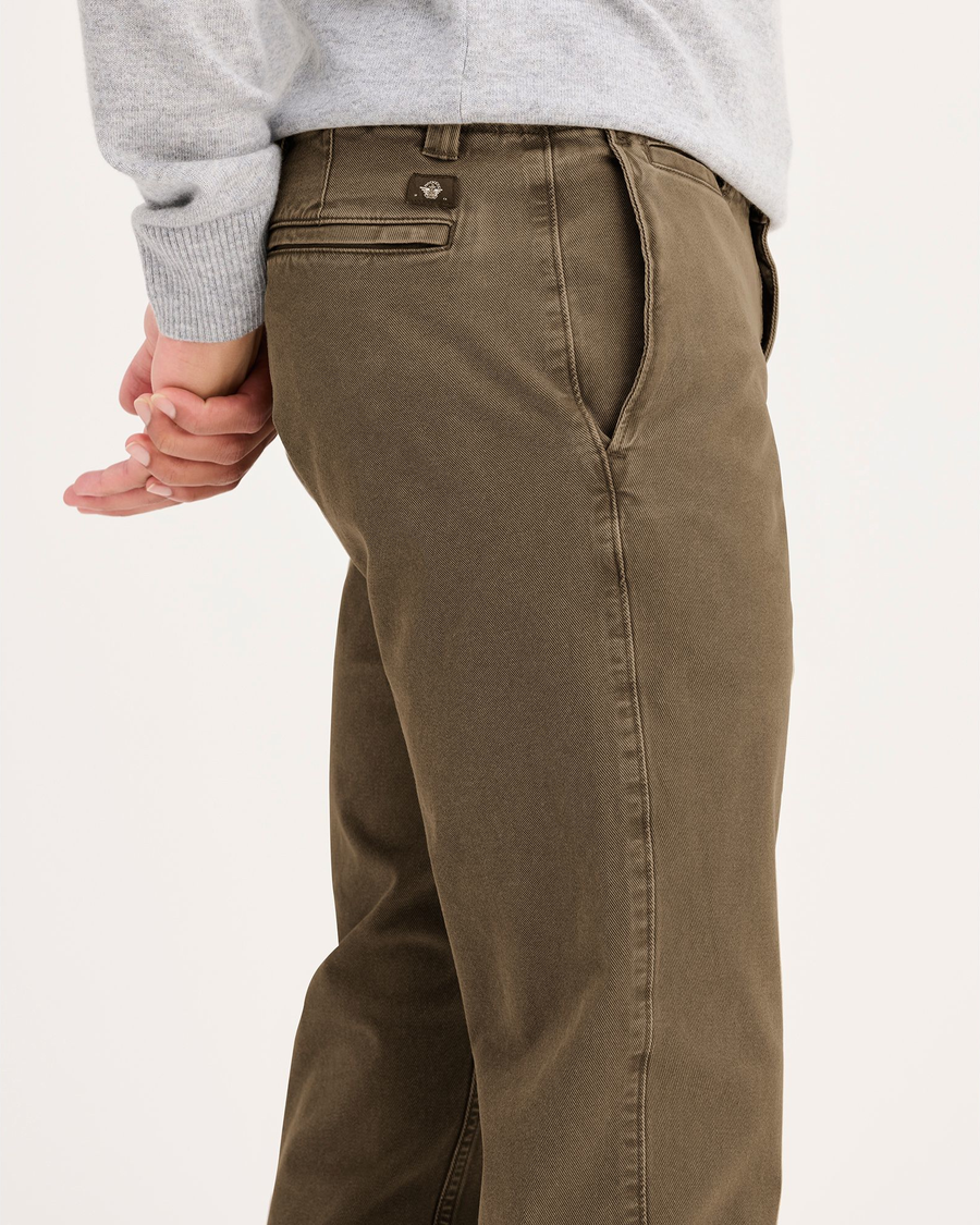 Side view of model wearing Otter Stonewash Men's Slim Fit Smart 360 Flex California Chino Pants.