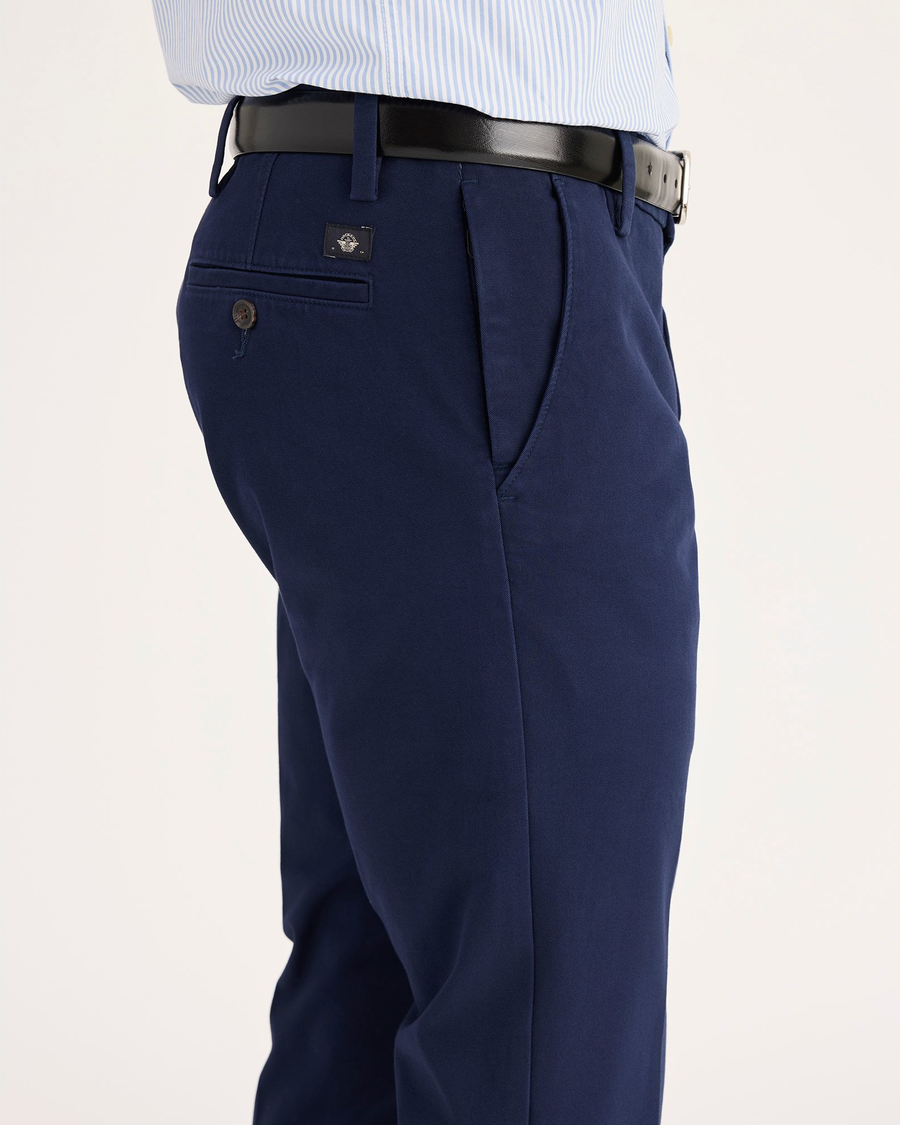 Side view of model wearing Pembroke Men's Slim Fit Smart 360 Flex Workday Khaki Pants.