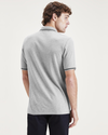 Back view of model wearing Smokestack Heather Men's Slim Fit Original Polo.